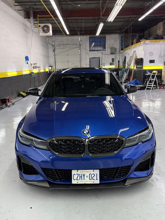 Blue BMW car in a warehouse setting